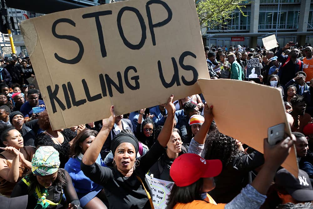 A woman holds a sign as demonstrators gather Sept. 4, 2019, at the World Economic Forum on Africa in Cape Town during a protest against gender-based violence. (Credit: CNS photo/Sumaya Hisham, Reuters.)