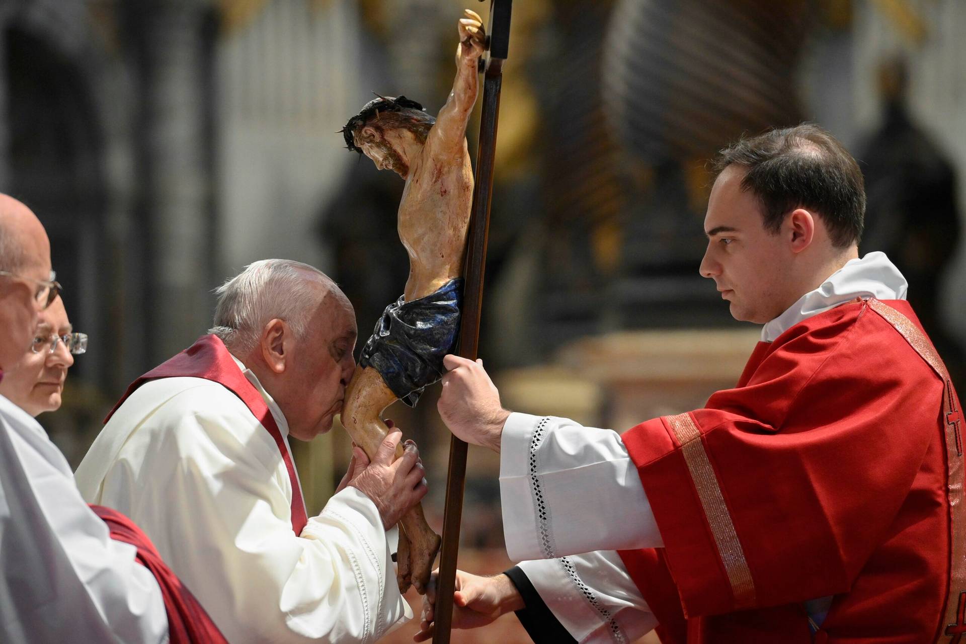 Pope Francis kisses a crucifix during the Good Friday Liturgy of the Lord's Passion in St. Peter's Basilica at the Vatican April 7, 2023. (Credit: Vatican Media.)