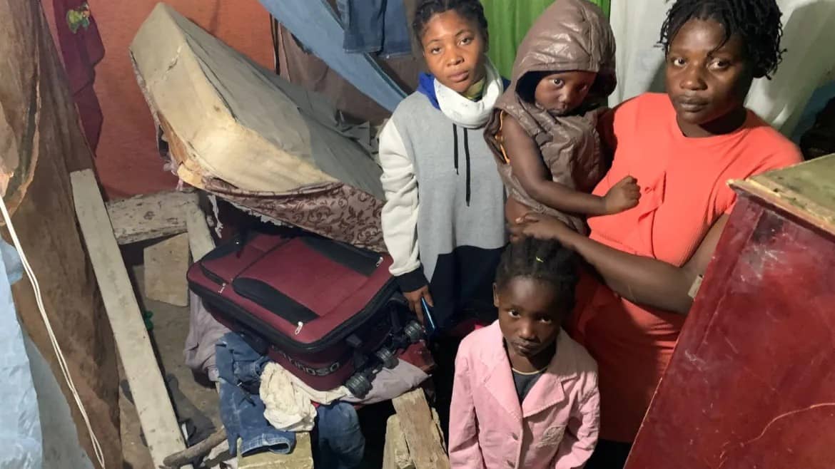 Haitian families living in Villa Guerrero, where immigration agents stormed several houses on Mar. 15 in order to detain and deport Haitian immigrants. (Credit: Radio Seibo.)