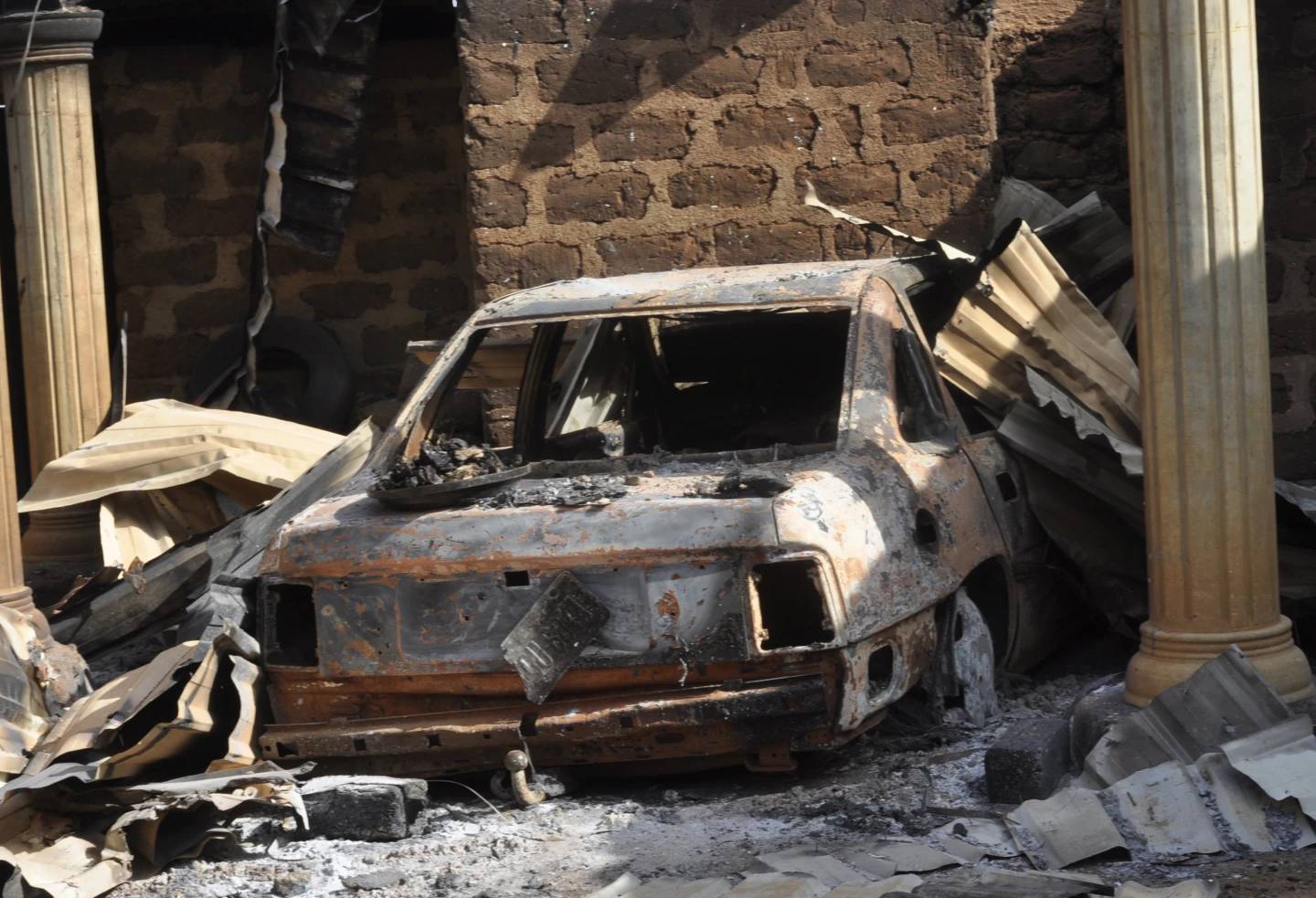 A burnt out car is seen following an attacked by gunmen in Bokkos, north central Nigeria, Tuesday, Dec. 26, 2023. Nigerian officials and survivors say at least 140 people were killed by gunmen who attacked remote villages in north-central Nigeria’s Plateau state. (Credit: AP.)