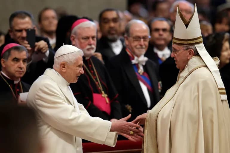 In this file photo, Benedict XVI, left, greets Pope Francis in St Peter's Basilica at the Vatican. (Credit: Andrew Medichini/AP.)