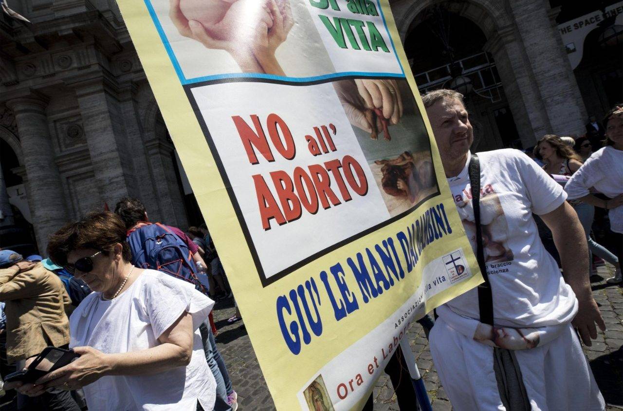 An Italian pro-life protestor with a sign reading, "No to abortion: Hands off children." (Credit: Vatican Media.)