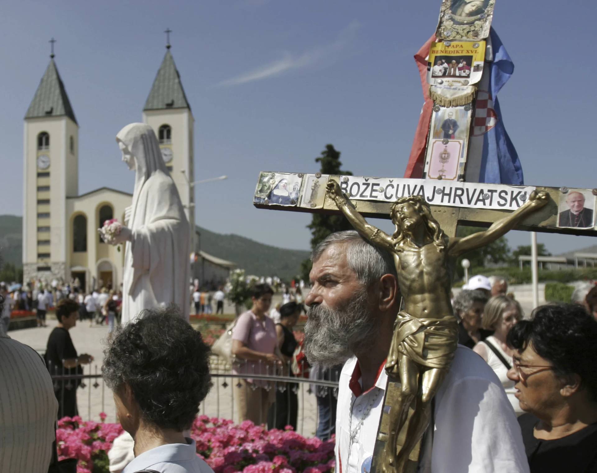 Pilgrims walk around a statue of the Blessed Virgin Mary near the church of St. James in Medjugorje, Bosnia and Herzegovina, about 75 miles south of the Bosnian capital of Sarajevo on Sunday, June 25, 2006. On Friday, May 17, 2024, the Vatican issued revised norms for discerning apparitions “and other supernatural phenomena,” updating a set of guidelines first issued in 1978. (Credit: Amel Emric/AP.)