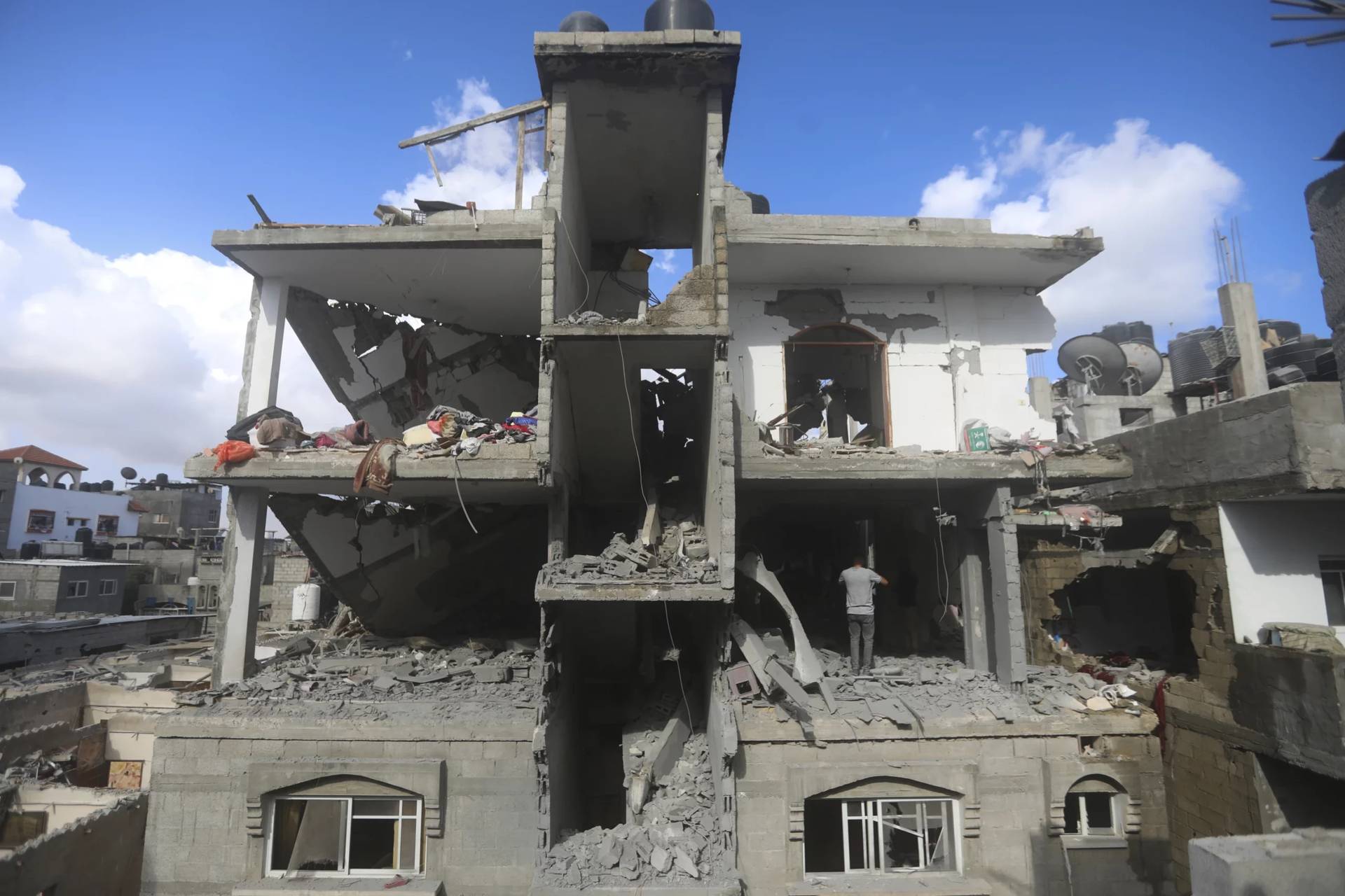 Palestinians look at the destruction caused by an Israeli strike on Rafah, in Gaza, May 7, 2024. (Credit: Ismael Abu Dayyah/AP.)