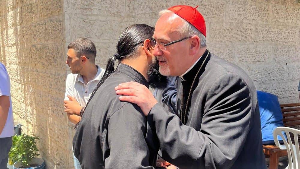 Cardinal Pierbattista Pizzaballa hugs a person at the Church of the Holy Family in Gaza, May 16, 2024. (Credit: Latin Patriarchate of Jerusalem.)