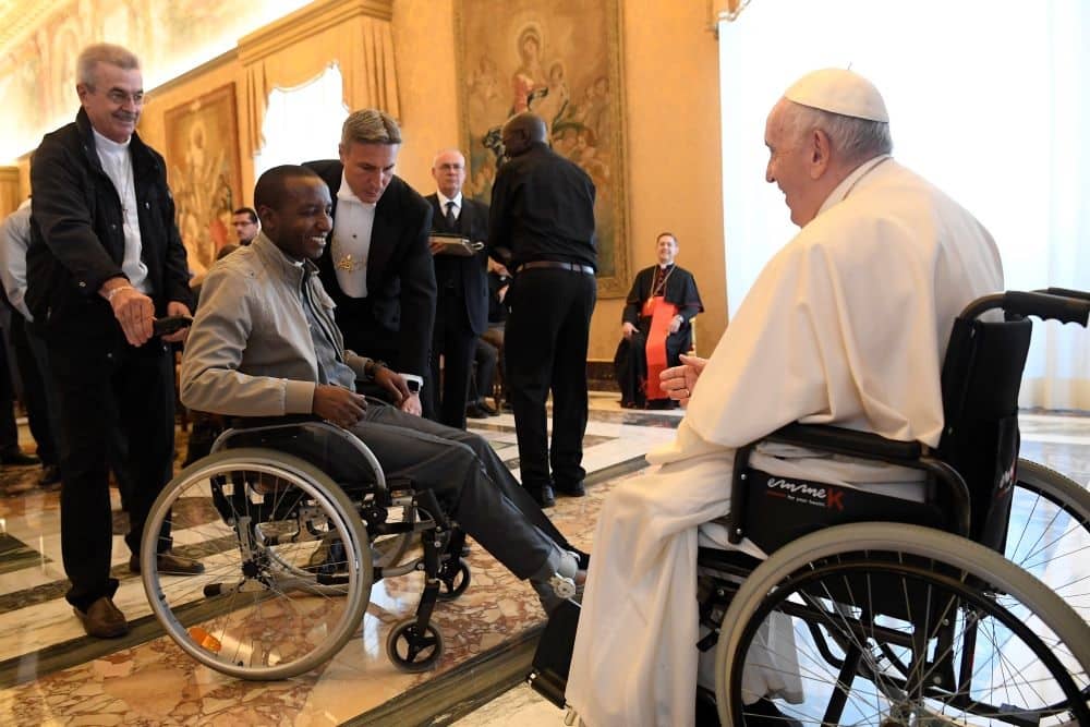 Pope Francis greets a cleric in a wheelchair during an audience with participants attending the general chapter of the Comboni Missionaries at the Vatican June 18, 2022. (Credit: Vatican Media.)