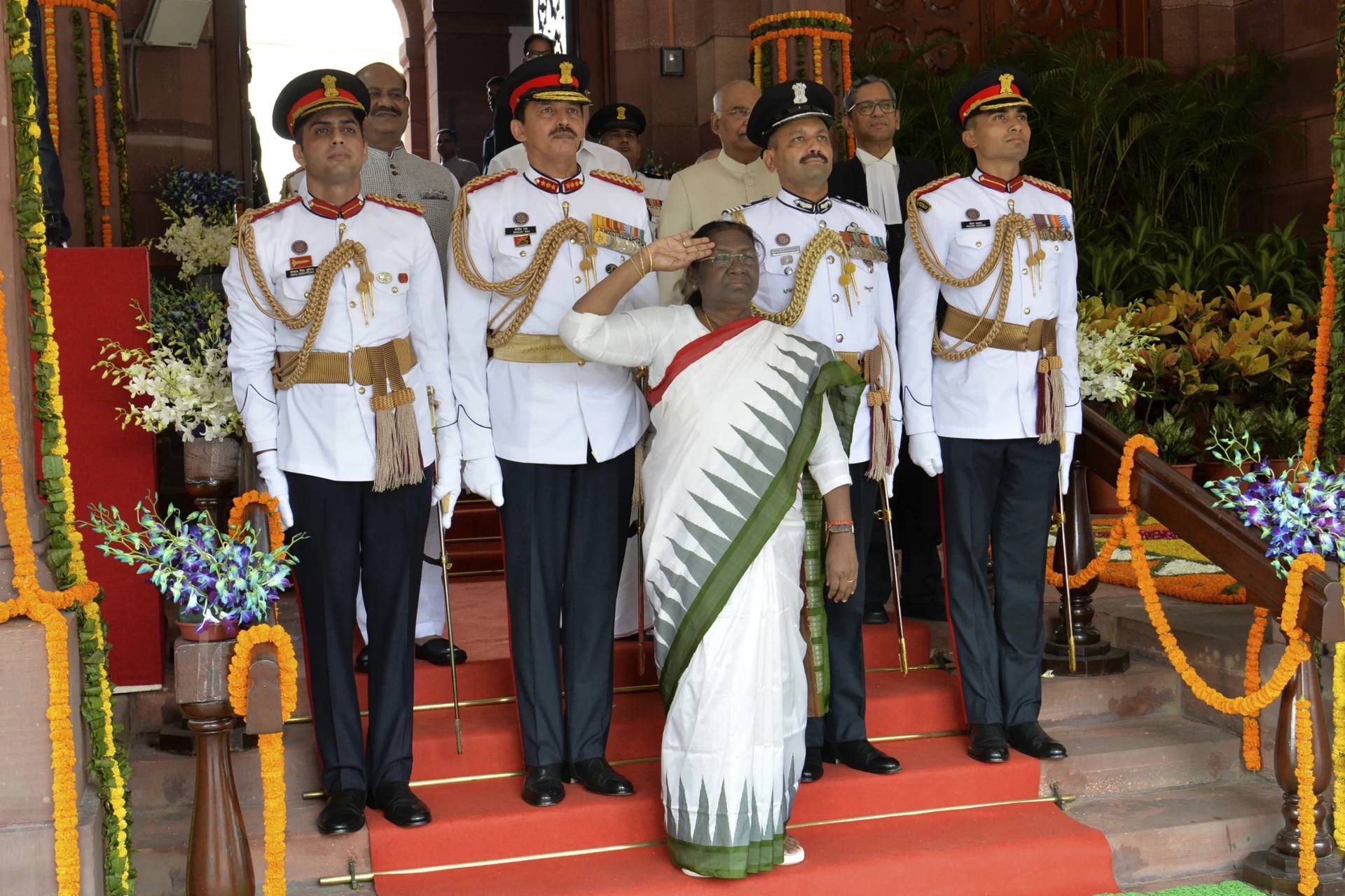 In this photograph released by India’s Presidential Palace, India’s new president Draupadi Murmu, salutes as she receives a guard of honor during her swearing in ceremony in New Delhi, India, July 25, 2022. India’s president on Thursday inaugurated a new parliament session after the national election, listing priorities of Prime Minister Narendra Modi’s government in coming years, including fast-tracking economic reforms and boosting small and medium enterprises to create jobs.( Credit: India’s Presidential Palace via AP.)
