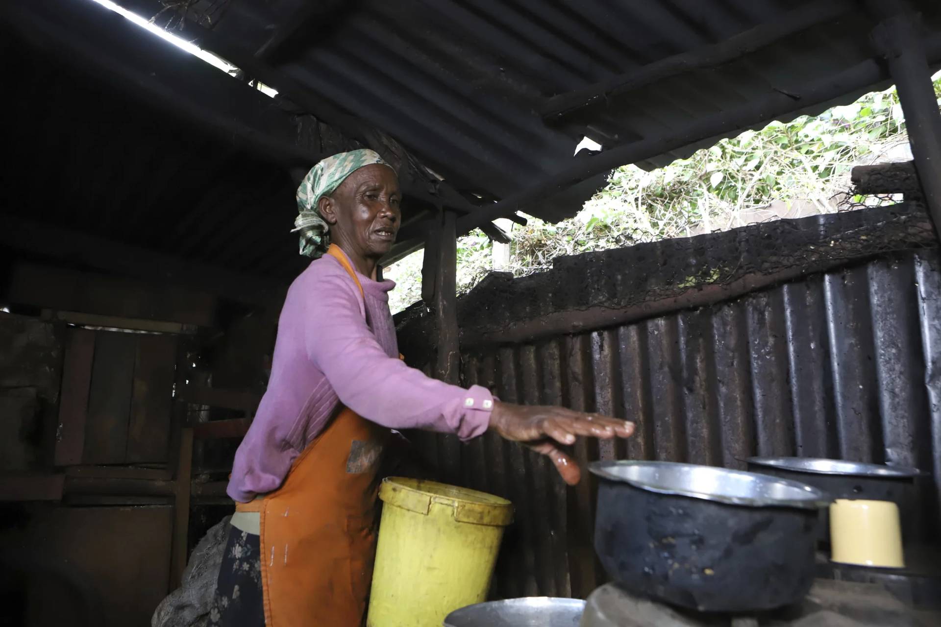 Jane Muthoni cleans up utensils at her home in Kiambu, Kenya, on May 22, 2024. (Credit: Andrew Kasuku/AP.)
