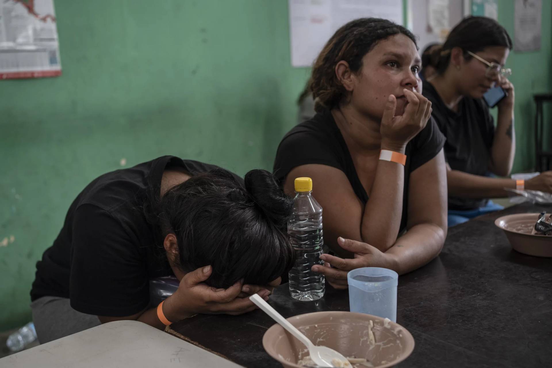Yeneska Garcia, a Venezuelan migrant, cries into her hands as she eats at the Peace Oasis of the Holy Spirit Amparito shelter in Villahermosa, Mexico, Friday, June 7, 2024. Since the 23-year-old fled Venezuela in January, she trekked days through the jungles of The Darien Gap, narrowly survived being kidnapped by Mexican cartels and waited months for an asylum appointment with the U.S. that never came through. (Credit: Felix Marquez/AP.)