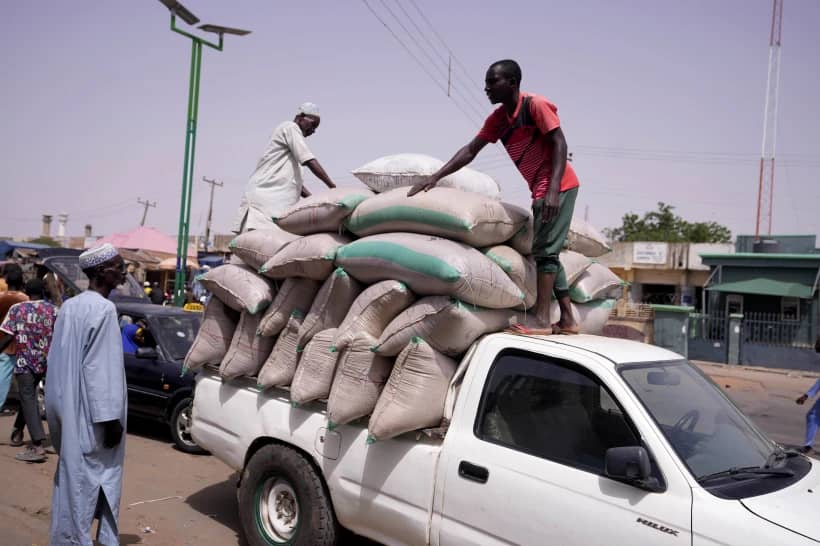 Workers offload bags of grains from a truck at a market in Gombe, Nigeria, on June 3, 2024. (Credit: Sunday Alamba/AP.)