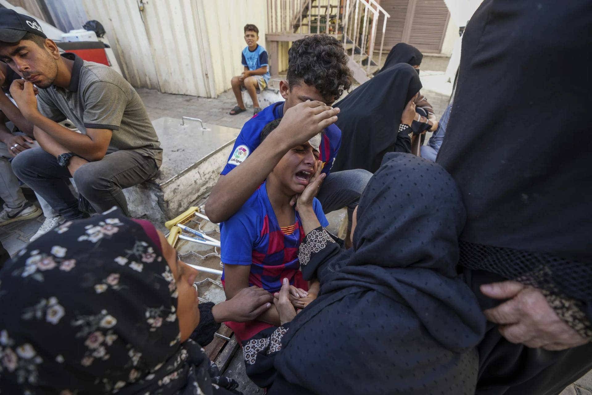 Palestinians mourn their relatives killed in the Israeli bombardment of the Gaza Strip in a hospital in Deir al Balah on June 18, 2024. (Credit: Abdel Kareen Hana/AP.)