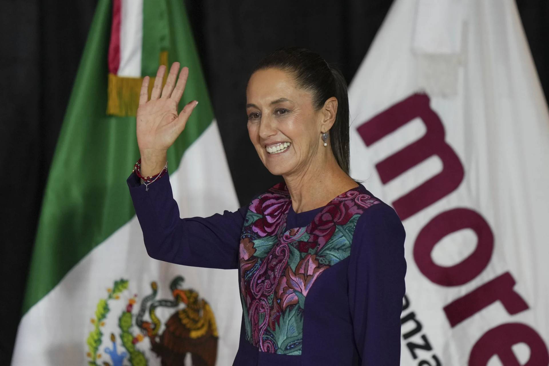 Claudia Sheinbaum, who begins her six-year presidential term Oct. 1, waves to the crowd after her election on Monday, June 2, 2024. (Credit: Fernando Llano/AP.)
