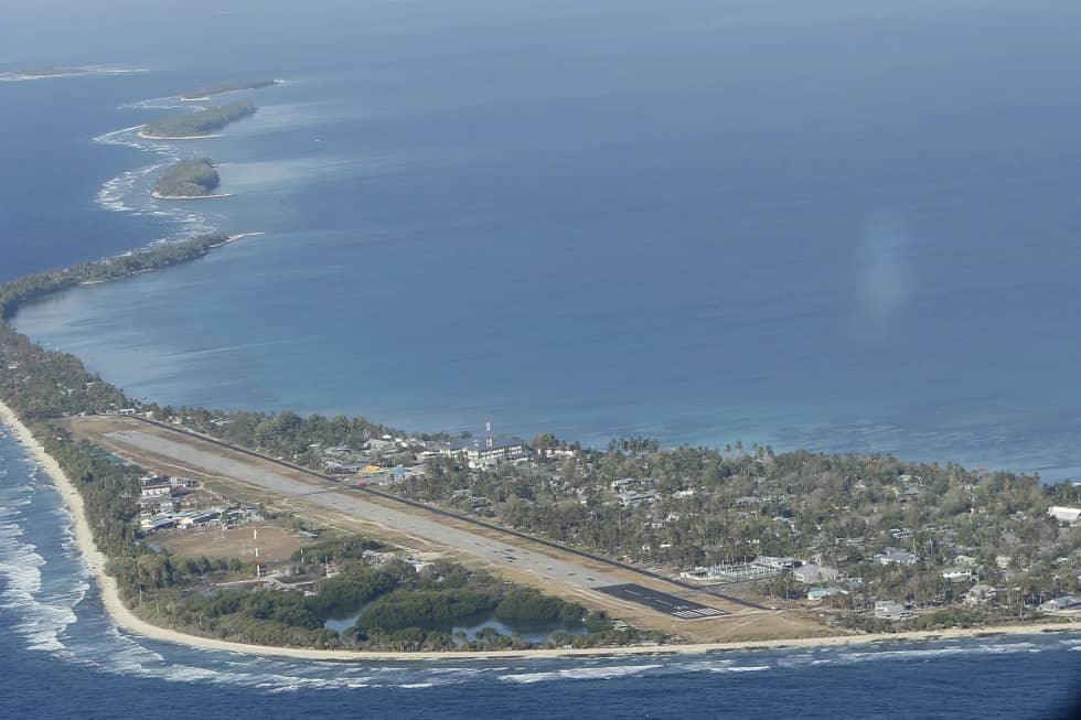 Funafuti, the main island of the nation state of Tuvalu, is photographed on Oct. 13, 2011, from a Royal New Zealand Air Force C130 aircraft as it approaches the tiny South Pacific nation. (Credit: Alastair Grant/AP.)