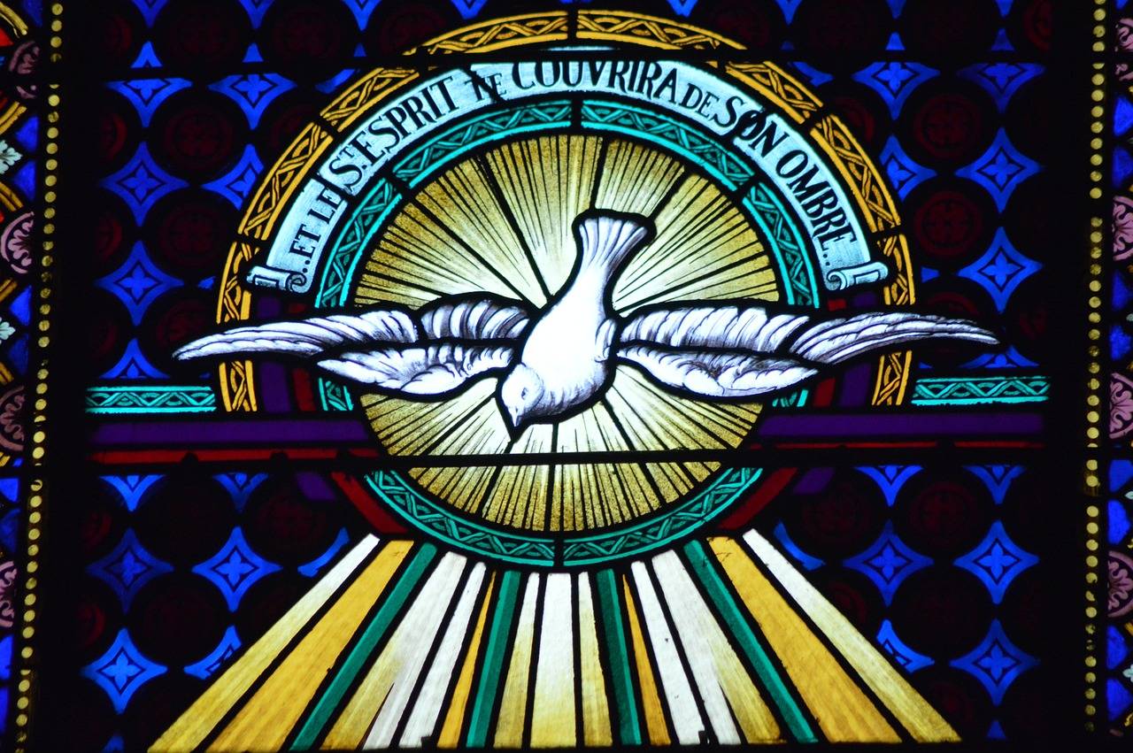 The Holy Spirit in a stained glass window. (Credit: Pixabay.)