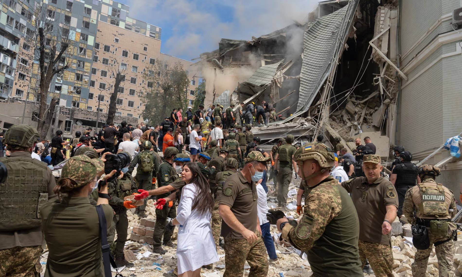 Rescuers, volunteers and medical workers search for survivors after a Russian missile attack on Ukraine’s biggest children’s hospital. (Credit: Efrem Lukatsky/AP.)