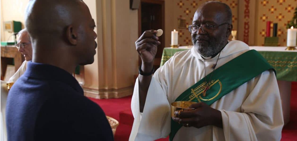 Deacon Willard Witherspoon distributes Communion during Mass at St. Peter Claver Church in Baltimore in this 2016 file photo. (Credit: Bob Roller/CNS.)