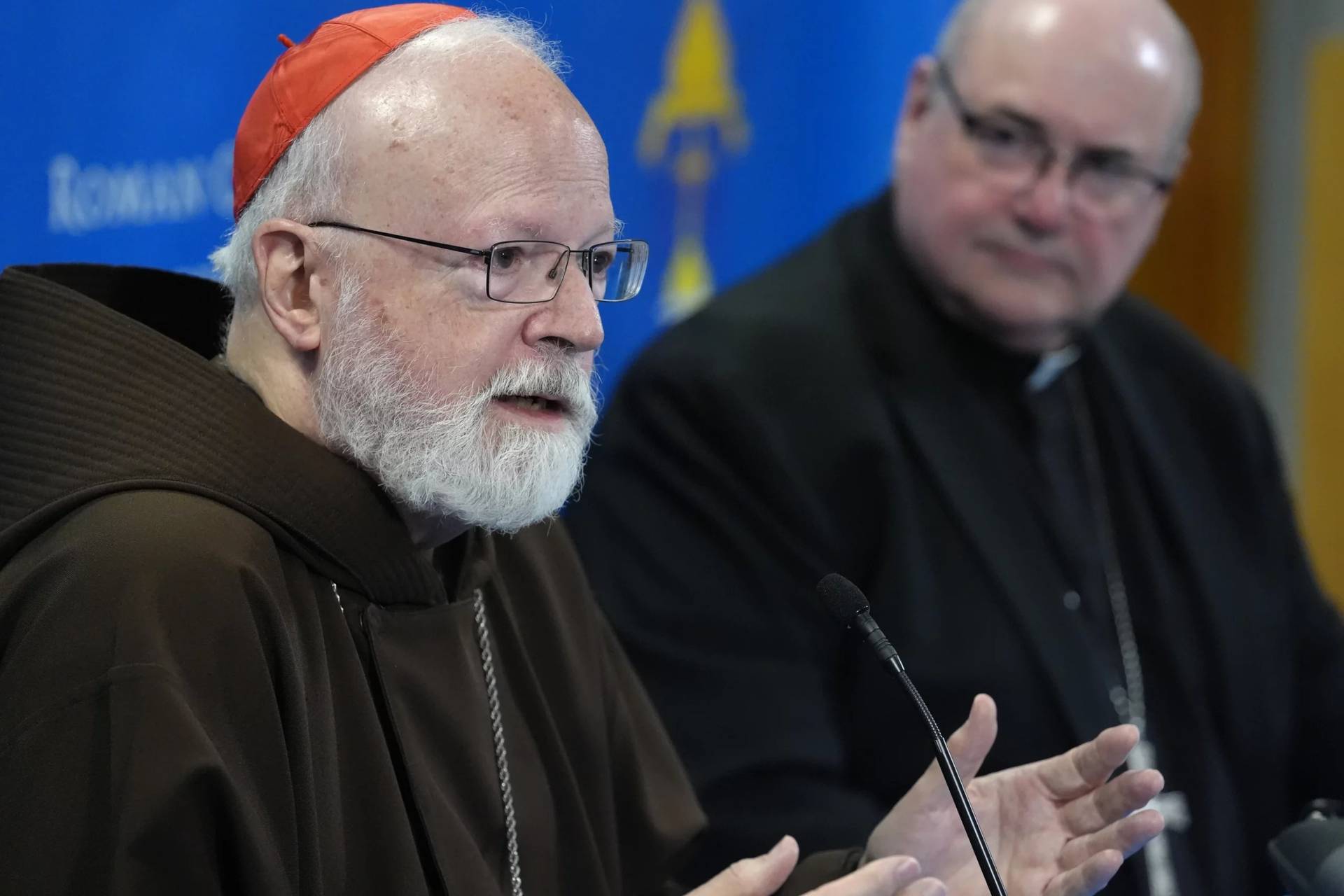 Cardinal Seán P. O’Malley answers a reporter’s question at a joint press conference with Archbishop Richard G. Henning held Aug. 5 at the Archdiocese of Boston’s Pastoral Center to announce Archbishop Henning’s appointment as the next Archbishop of Boston. (Credit: Steven Senne/AP.)