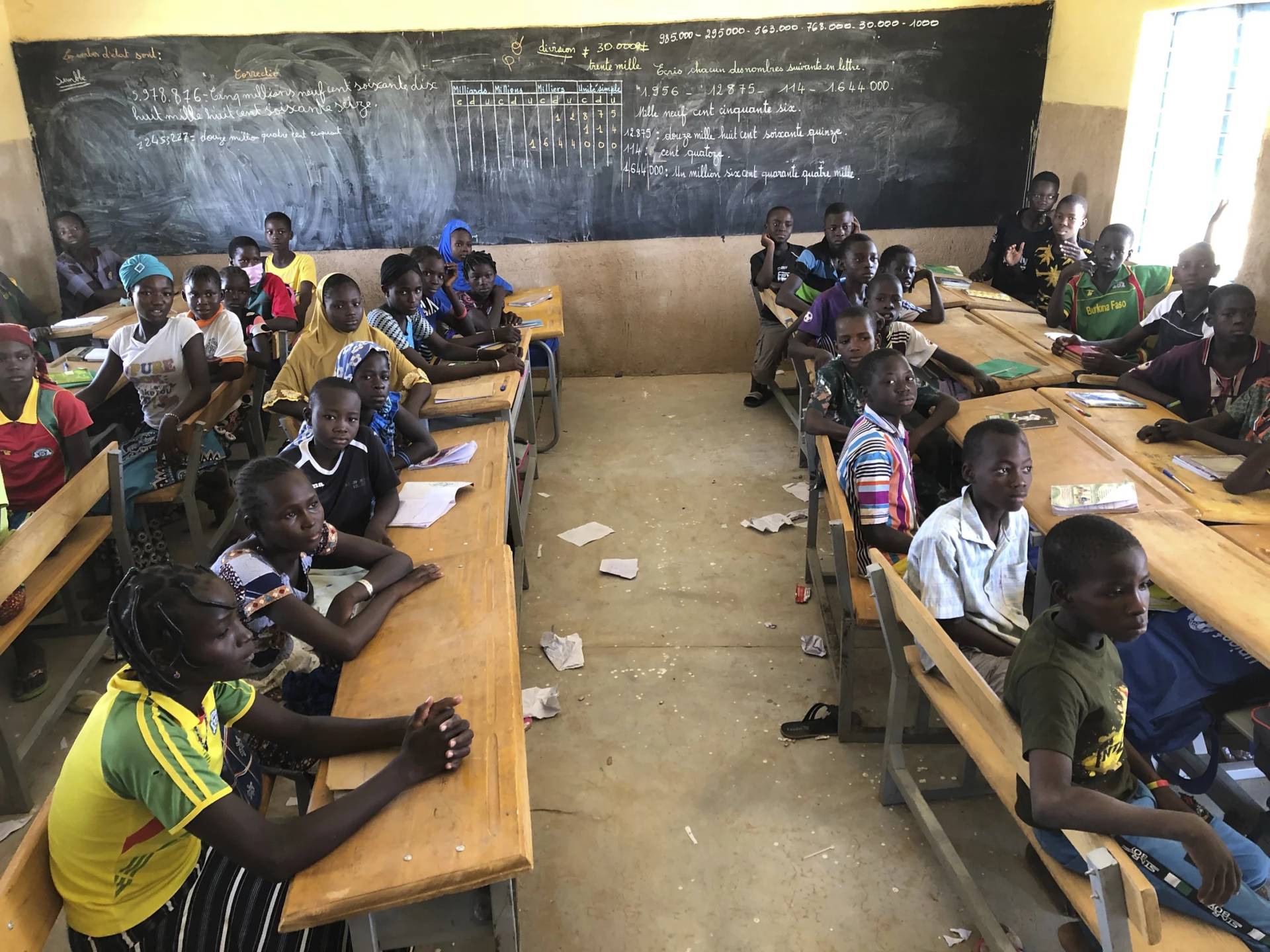 Children gather in a classroom at school in the village of Dori, Burkina Faso, Tuesday Oct. 20, 2020. More than half of the displaced by growing violence between Islamic extremists and security forces are children, and many are traumatized by their experiences. But mental health services in the West African country are limited, and children are often overlooked for treatment.(Credit: Sam Mednick/AP.)