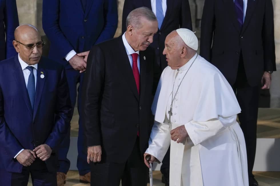 Turkey’s President Recep Tayyip Erdogan, center, talks to Pope Francis during a group photo at the G7 in Borgo Egnazia, near Bari in southern Italy, June 14, 2024. (Credit: Luca Bruno/AP.)