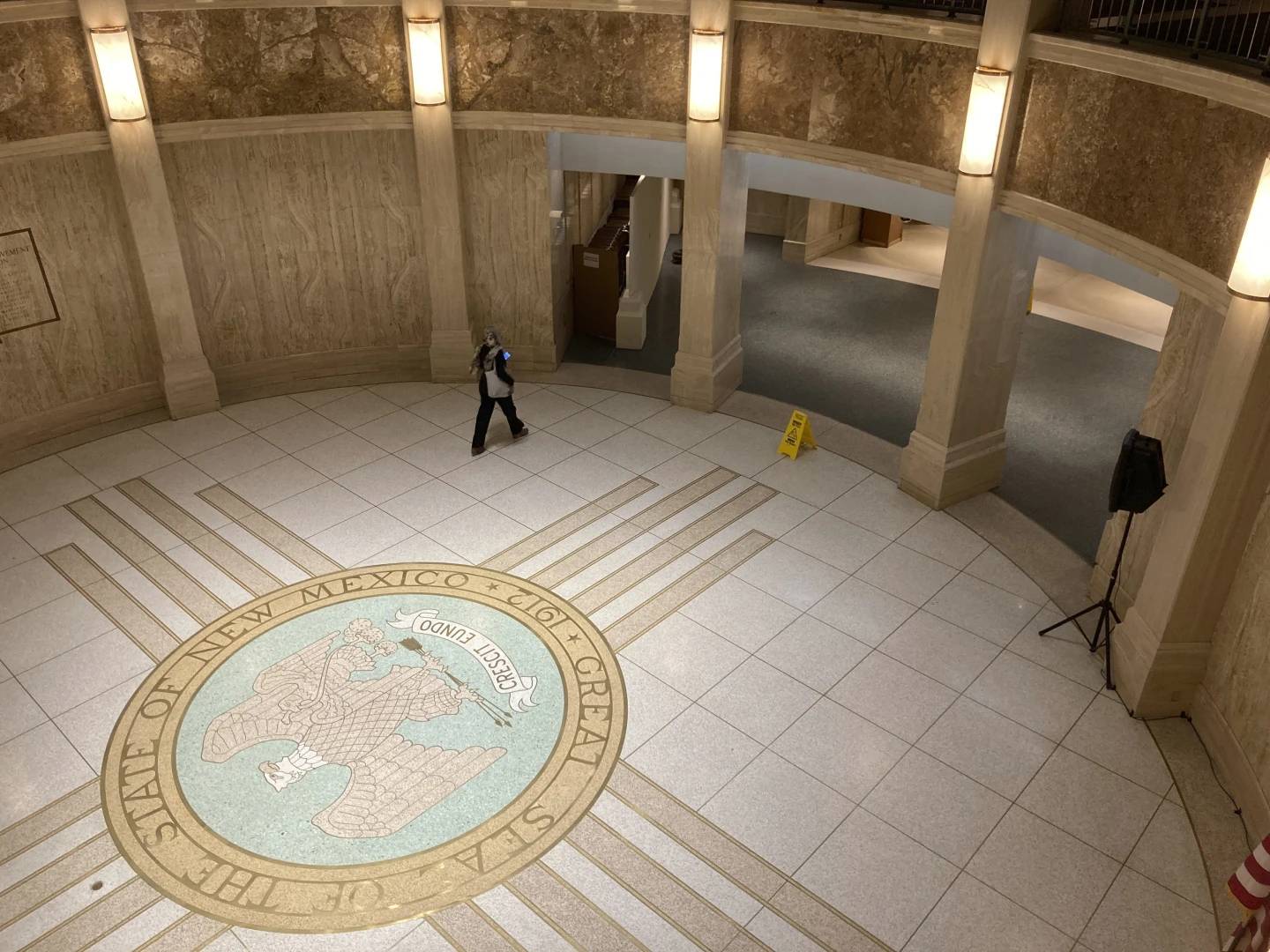 A pedestrian traverses the rotunda inside the New Mexico Capitol, March 16, 2023, in Santa Fe, N.M. (Credit: Morgan Lee/AP.)