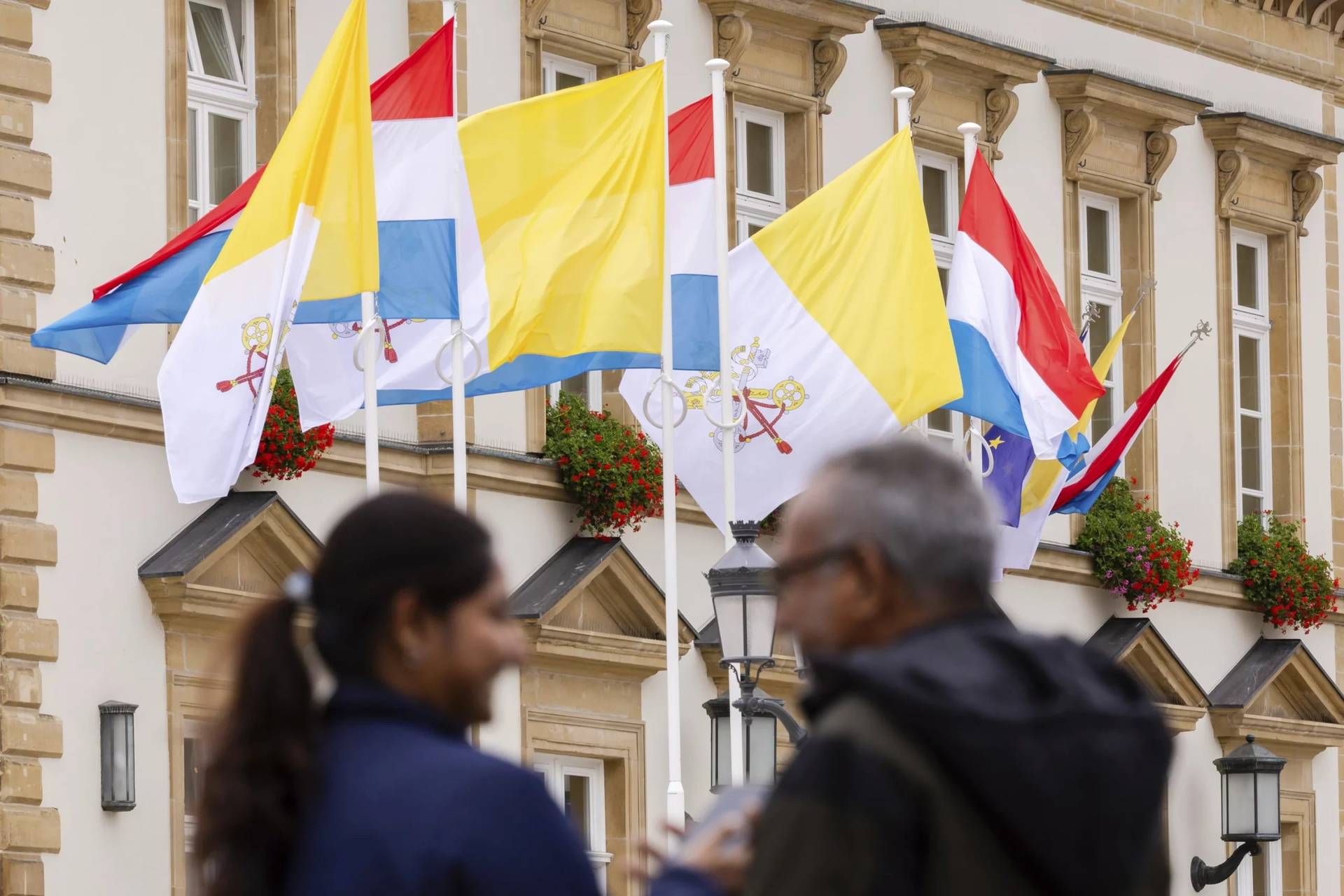 Flags of Vatican City and Luxembourg wave outside the Luxembourg City Hall a day before for the trip of Pope Francis to Luxembourg and Belgium, Wednesday, Sept. 25, 2024, (Credit: Geert Vanden Wijngaert/AP.)