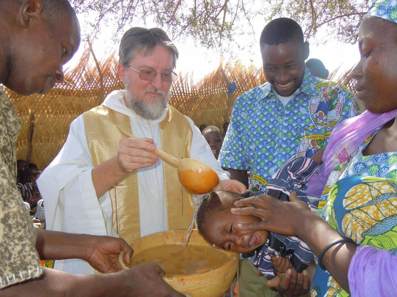 Father Pierluigi Maccalli, a member of the Society of African Missions, is pictured in a file photo baptizing a child in Bomoanga, Niger. (Credit: Raffaella Russitto/Courtesy Society of African Missions via CNS.)