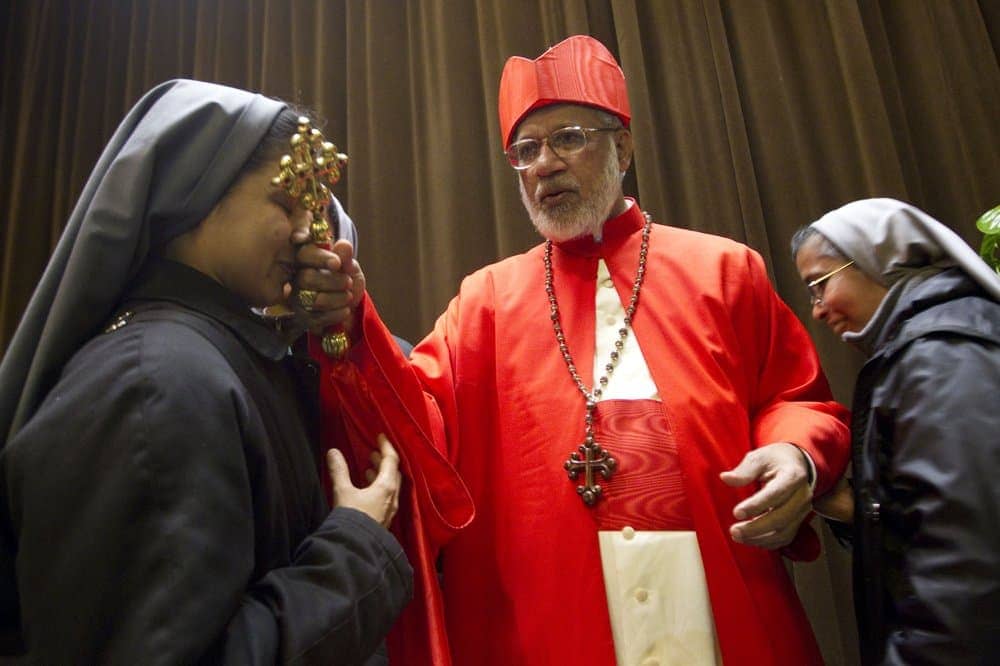 In this Feb. 18, 2012 file photo, the then-elected cardinal George Alencherry, of India, center, is greeted by nuns after being elevated in St. Peter’s Basilica at the Vatican. (Credit: Andrew Medichini/AP.)