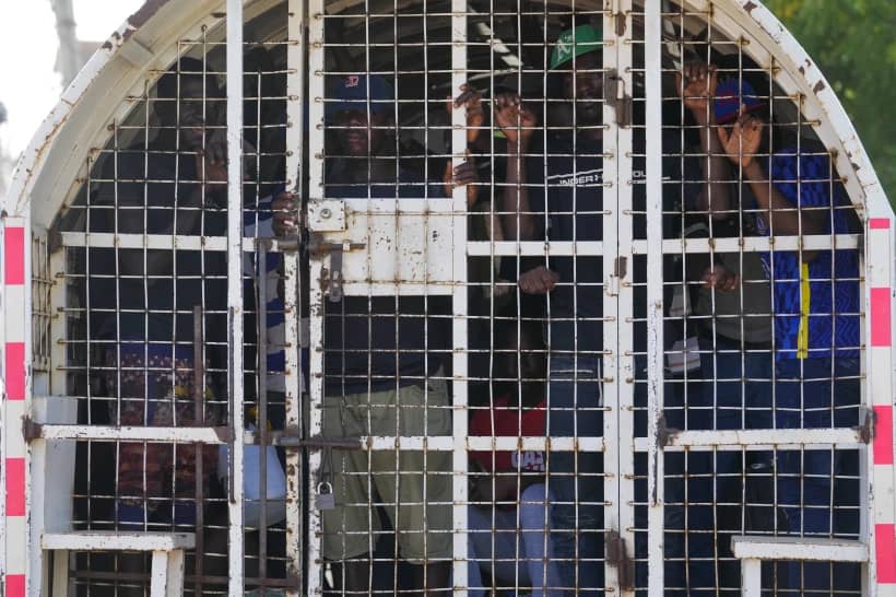 Undocumented Haitians detained by immigration officials stand inside a police vehicle, in Dajabon, Dominican Republic, May 17, 2024. (Credit: Matias Delacroix/AP.)