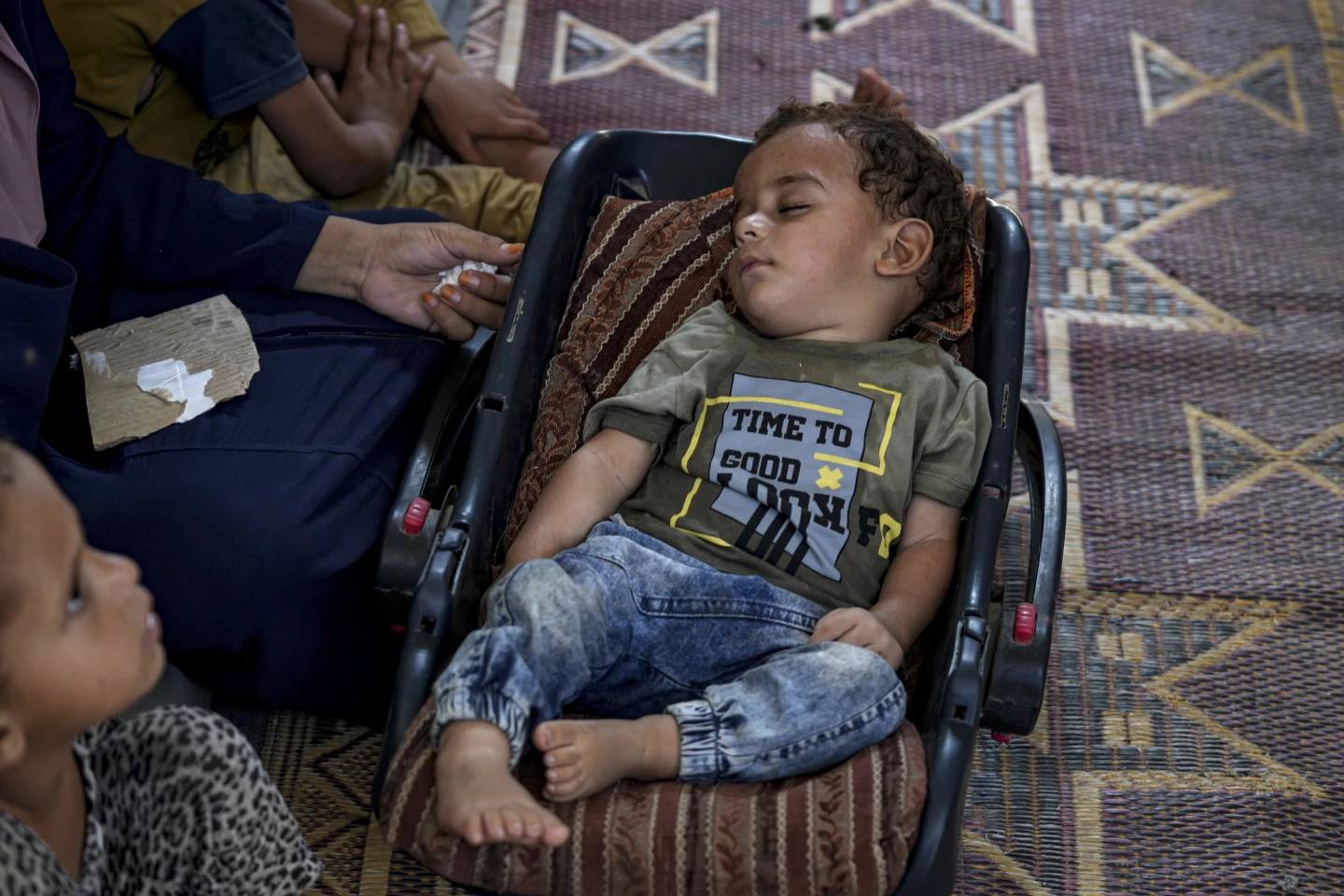 Displaced infant Abdel-Rahman Abu El-Jedian, who suffers from polio, sleeps at a makeshift tent camp in Deir al-Balah, central Gaza Strip, Tuesday, Aug. 27, 2024. (Credit: Abdel Kareem Hana/AP.)