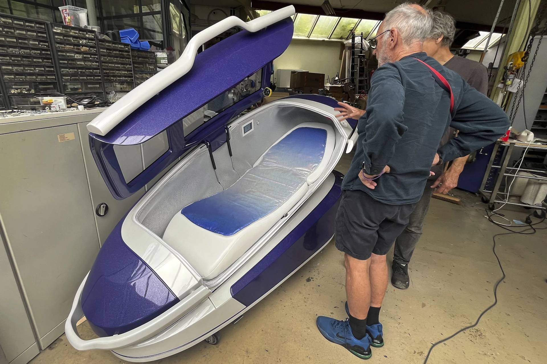 Philip Nitschke, front, stands next to a ‘suicide pod’ known as ‘The Sarco’ in Rotterdam, The Netherlands, July 8, 2024. (Credit: Ahmad Seir/AP.)