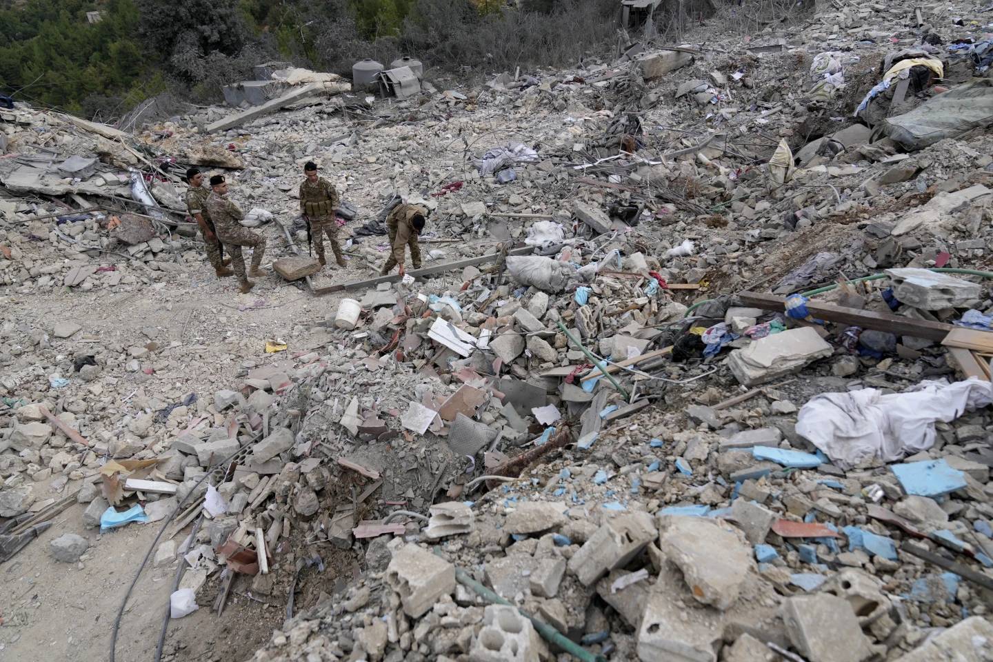 Lebanese army soldiers search on the rubble of a destroyed building at the site of Monday's Israeli airstrike in Aito village, north Lebanon, Tuesday, Oct. 15, 2024. (Credit: Hussein Malla/AP.)