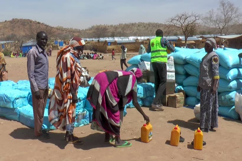 Sudanese refugees displaced by the conflict in Sudan gather to receive food staples from aid agencies at the Metche Camp in eastern Chad Tuesday, March 5, 2024. (Credit: Jsarh Ngarndey Ulrish/AP.)