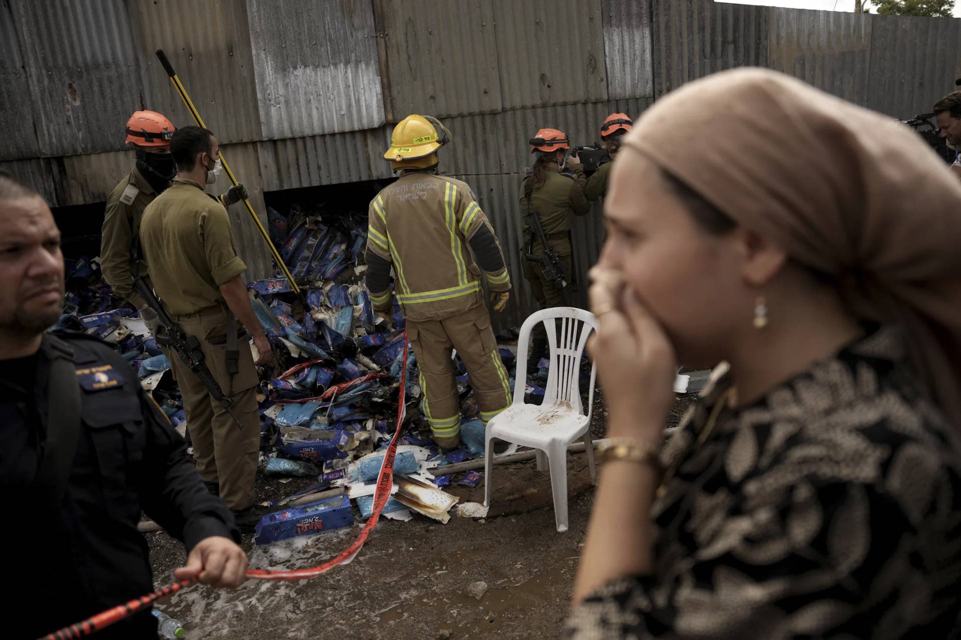 A woman reacts as emergency personnel respond after a rocket apparently fired from Gaza hits Kfar Chabad Tel Aviv, Monday, Oct. 7, 2024. (Credit: Oded Balilty/AP.)