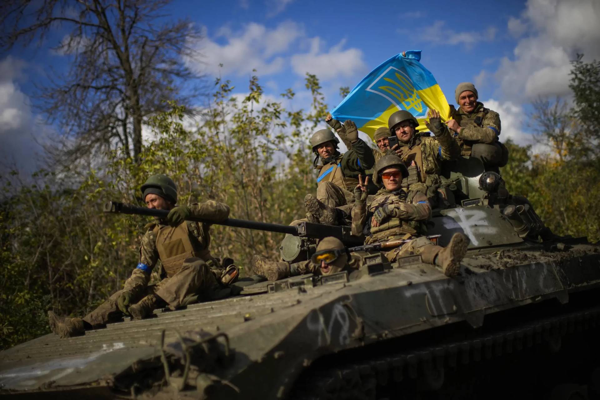 Ukrainian soldiers sit on an armoured vehicle as they drive on a road between Izium and Lyman in Ukraine, Tuesday Oct. 4, 2022. (Credit: Francisco Seco/AP.)