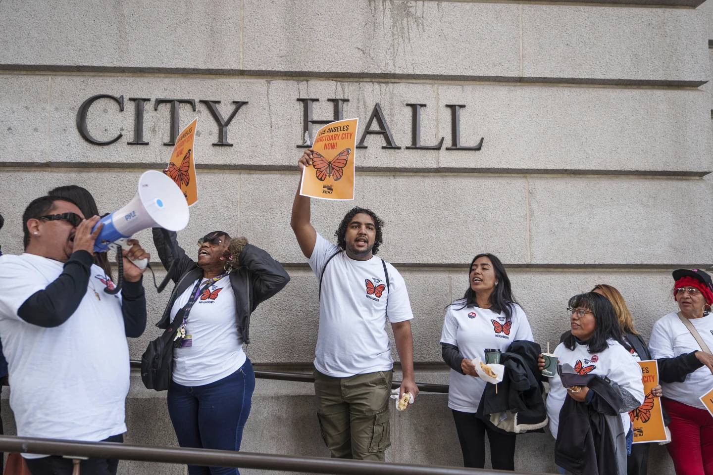 Members of immigration advocacy groups demand the City Council enact an ordinance making Los Angeles a sanctuary city outside Los Angeles City Hall in Los Angeles on Tuesday, Nov. 19, 2024. (Credit: Damian Dovarganes/AP.)