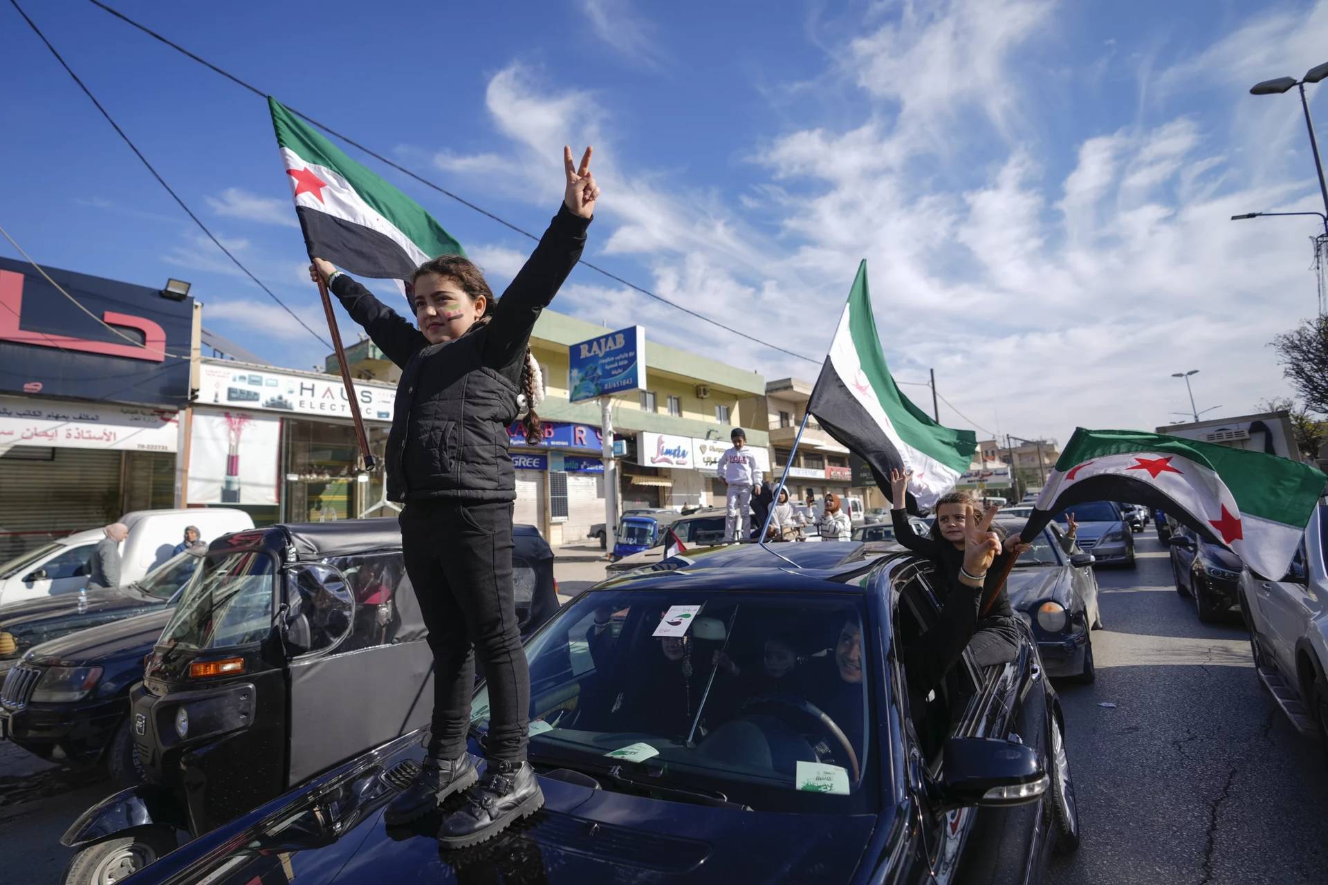 Syrians celebrate the fall of Bashar Assad’s government in the town of Bar Elias, Lebanon, near the border with Syria, Sunday, Dec. 8, 2024. (Credit: Hassan Ammar/AP.)