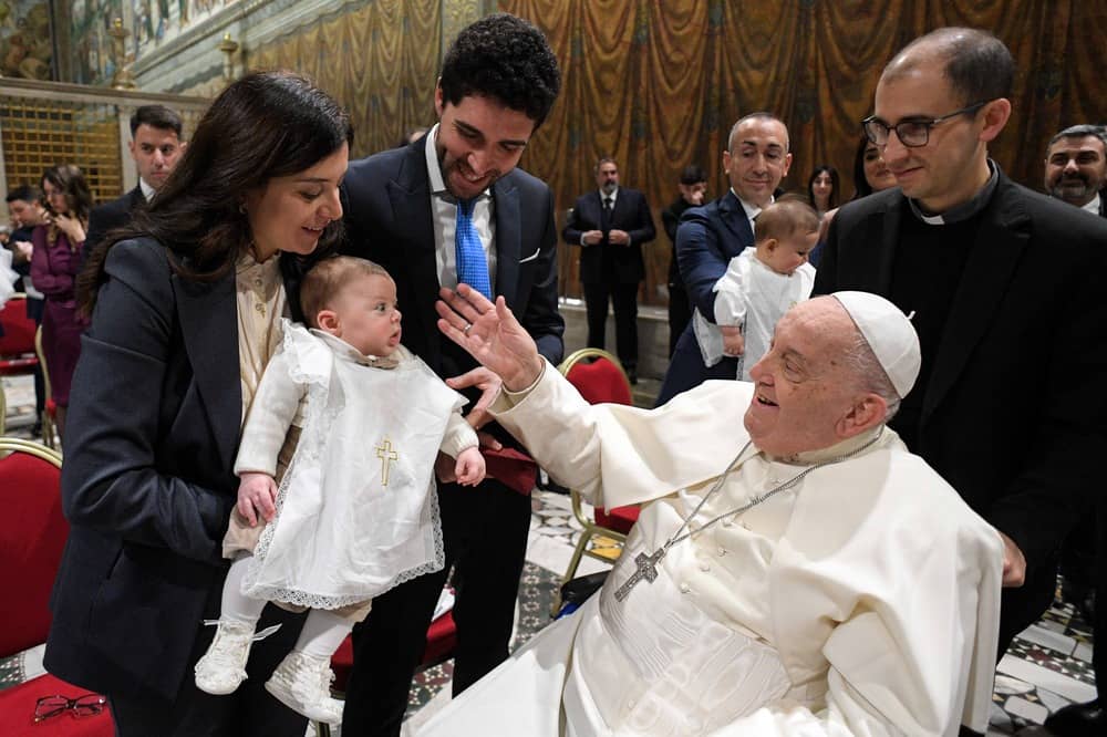 Pope Francis greets a child after he baptized him during Mass in the Sistine Chapel at the Vatican Jan. 12, 2025, the feast of the Baptism of the Lord. (Credit: Vatican Media.)