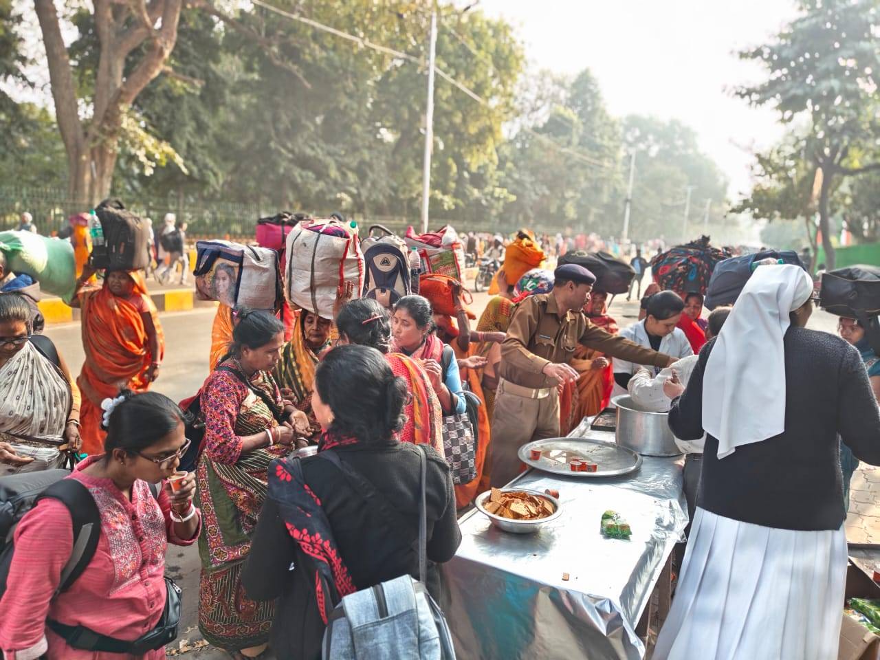 Stranded pilgrims being fed in Allahabad Catholic Diocese in India. They are in front of the Catholic hospital. (Credit: Bishop Louis Mascarenhas.)