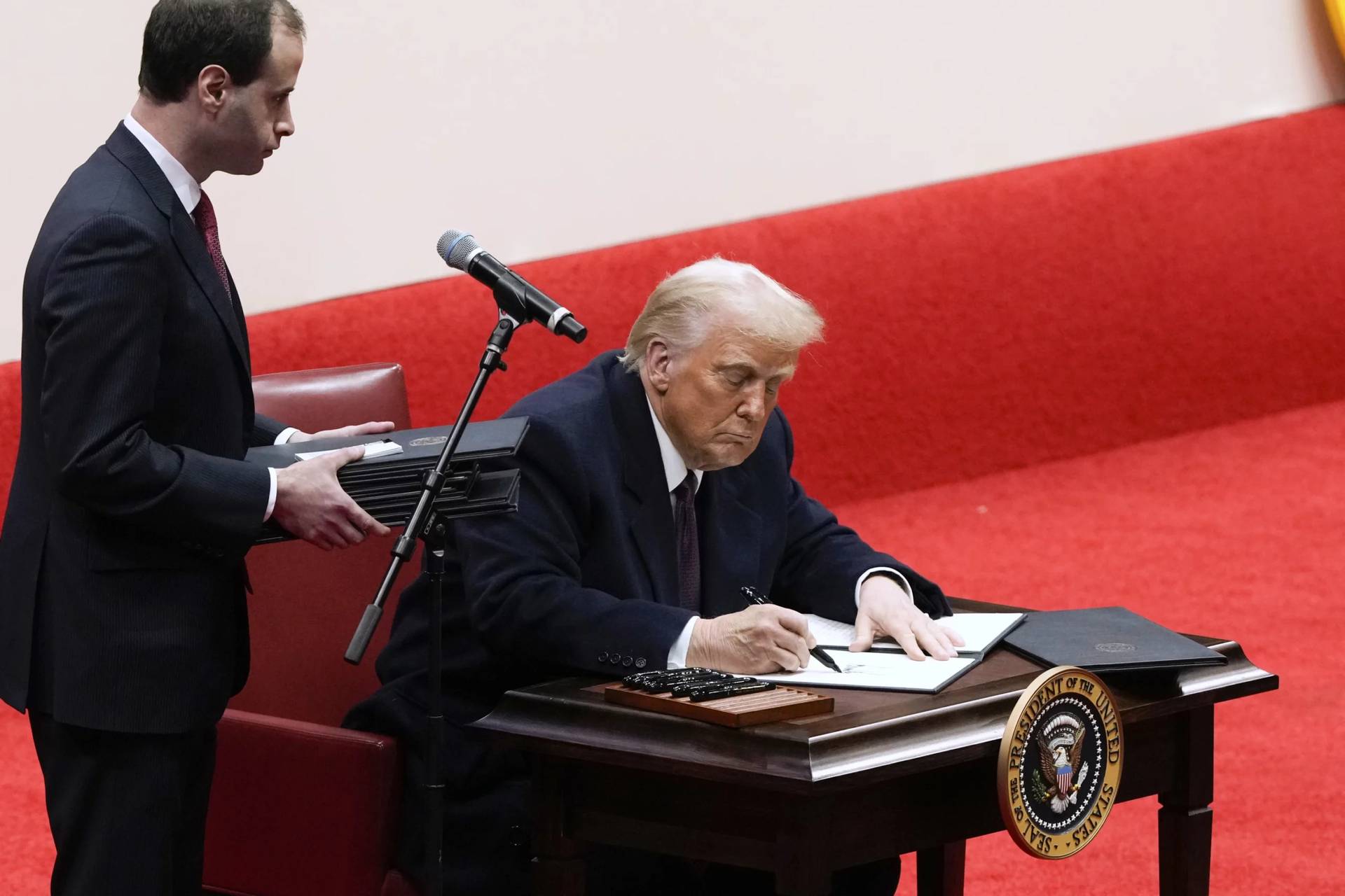 President Donald Trump signs executive orders in Washington, DC, on Jan 20, 2025. (Credit: Associated Press.)