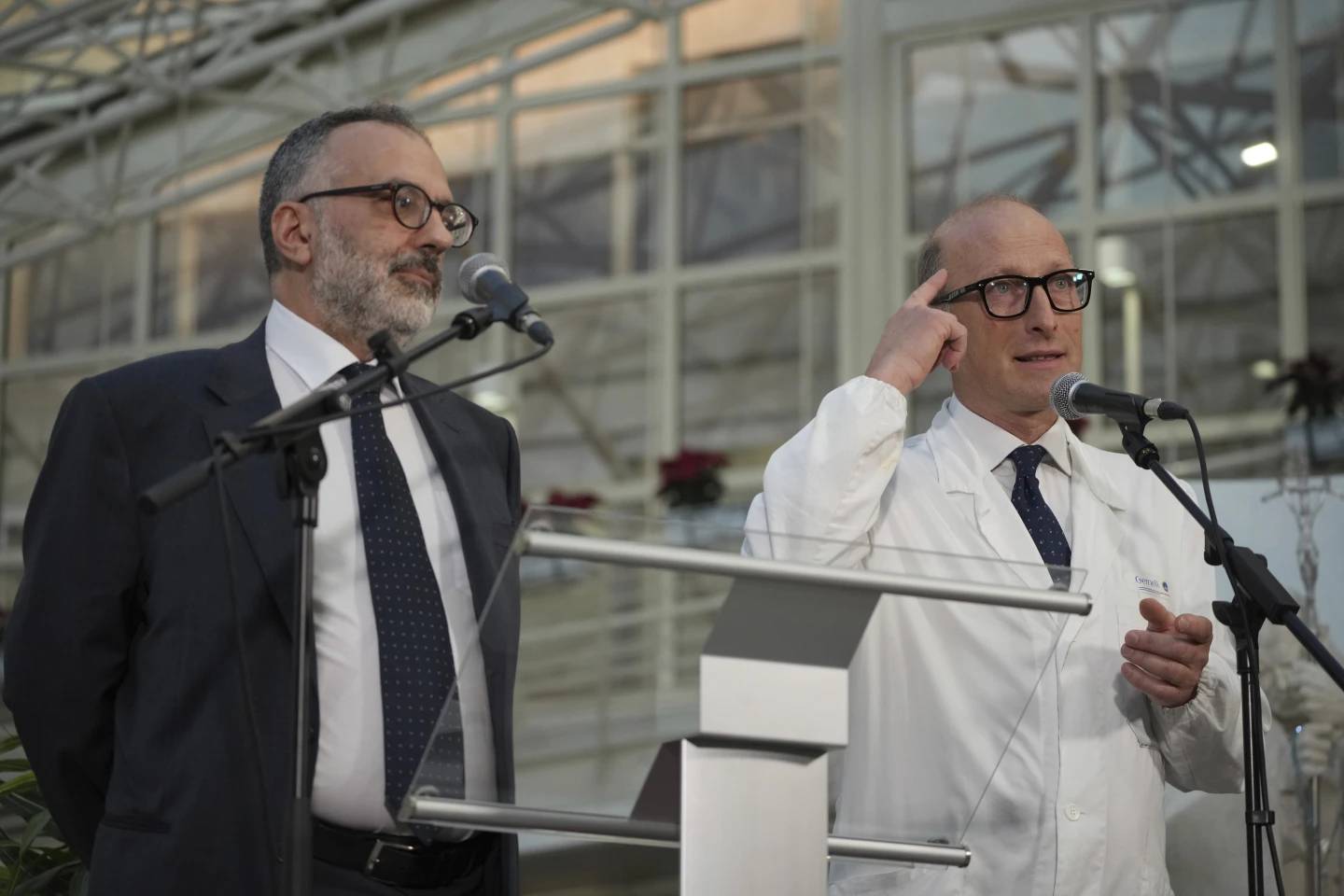 Surgeon Sergio Alfieri, right, and Pope Francis's personal doctor, Luigi Carboni, speak to journalists on Friday, Feb. 21, 2025, in the entrance hall of Rome's Gemelli Hospital. (Credit: Alessandra Tarantino./AP.)