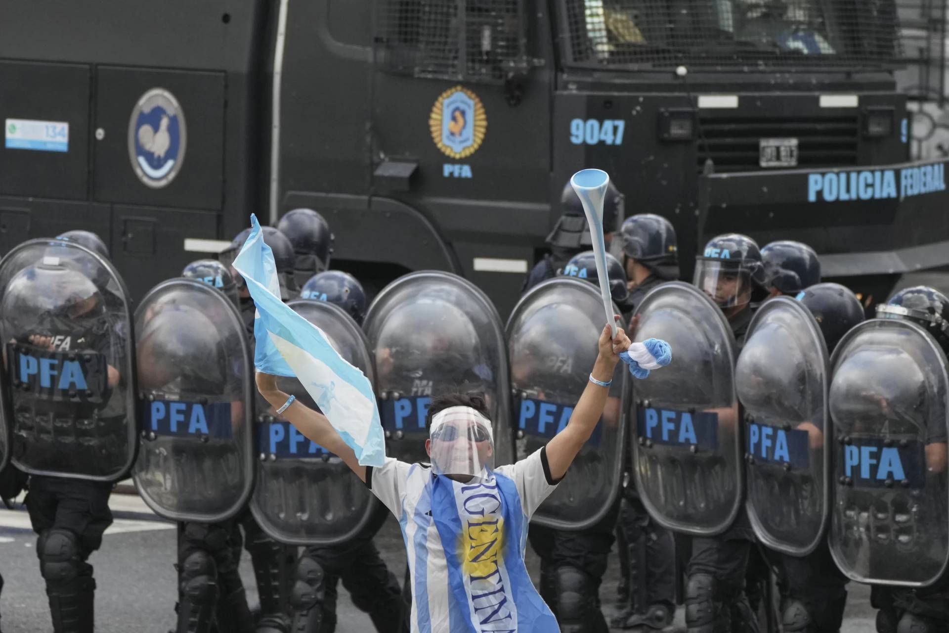 A soccer fan joins retirees protesting for higher pensions and against austerity measures implemented by President Javier Milei’s government in Buenos Aires, Argentina, Wednesday, March 12, 2025. (Credit: Natacha Pisarenko/AP.)