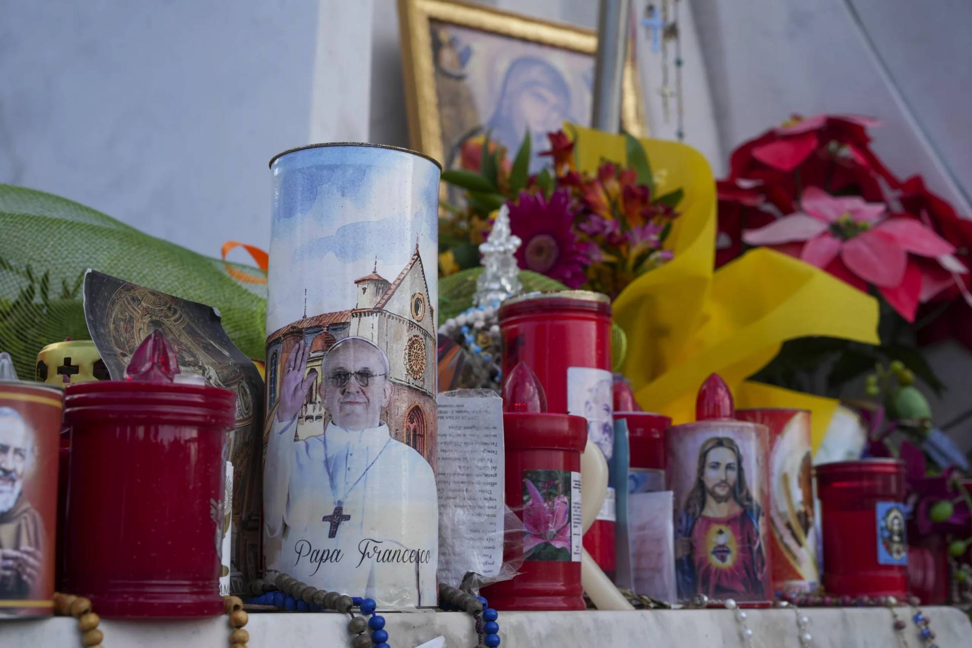 Candles and flowers for Pope Francis are seen in front of the Agostino Gemelli Polyclinic, in Rome, Saturday, March 15, 2025, where the Pontiff is hospitalized since Feb. 14. (Credit: Andrew Medichini/AP.)