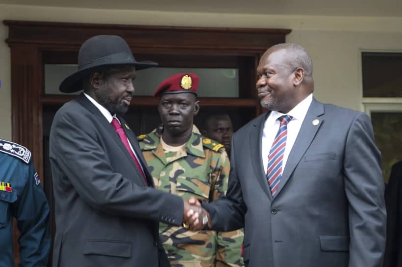 South Sudan’s president Salva Kiir, left, and vice-president Riek Machar, right, shake hands after meetings in Juba, South Sudan, on Oct. 20, 2019, to discuss outstanding issues to the peace deal. (Credit: Sam Mednick/AP.)