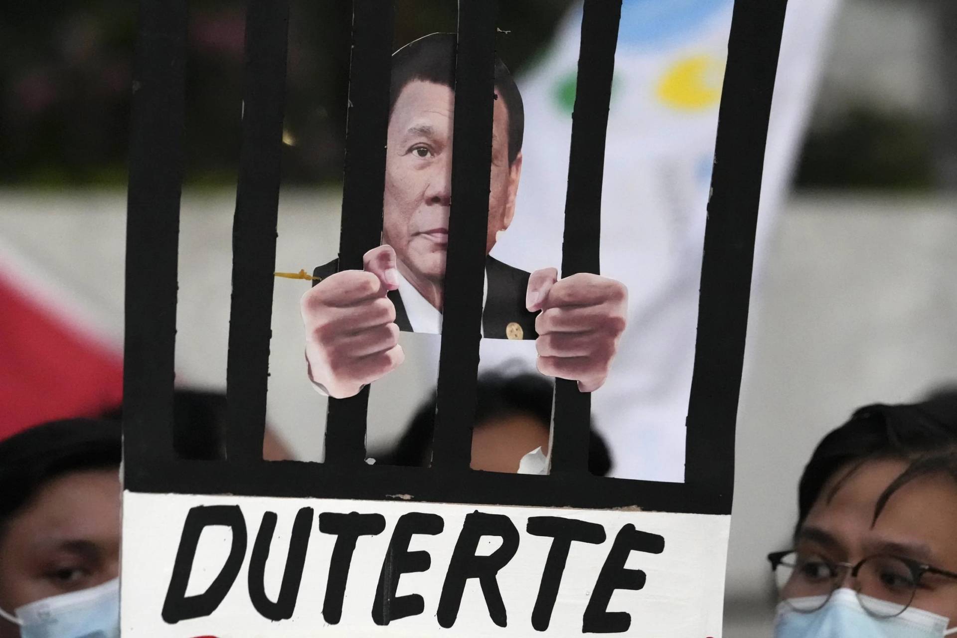 Protestors hold an illustration of former president Rodrigo Duterte behind bars as they call for justice to victims of the war on drugs during his administration in Quezon city, Philippines, on March 14, 2025. (Credit: Aaron Favila/AP.)