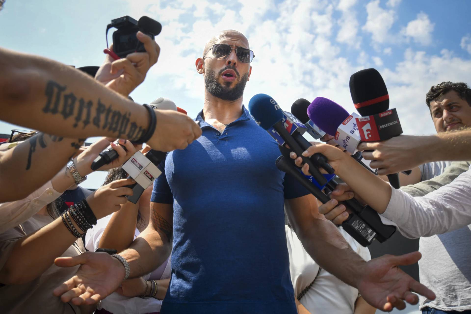 Andrew Tate speaks to media after being released from house arrest and put under judicial control measures, on the outskirts of Bucharest, Romania, Aug. 4, 2023. (Credit: Alexandru Dobre/AP.)