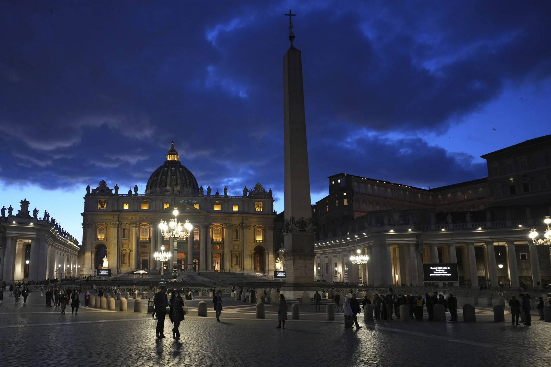 People walk at dusk in St Peter’s Square at The Vatican, Thursday, Feb. 27, 2025. (Credit: Kirsty Wigglesworth/AP.)