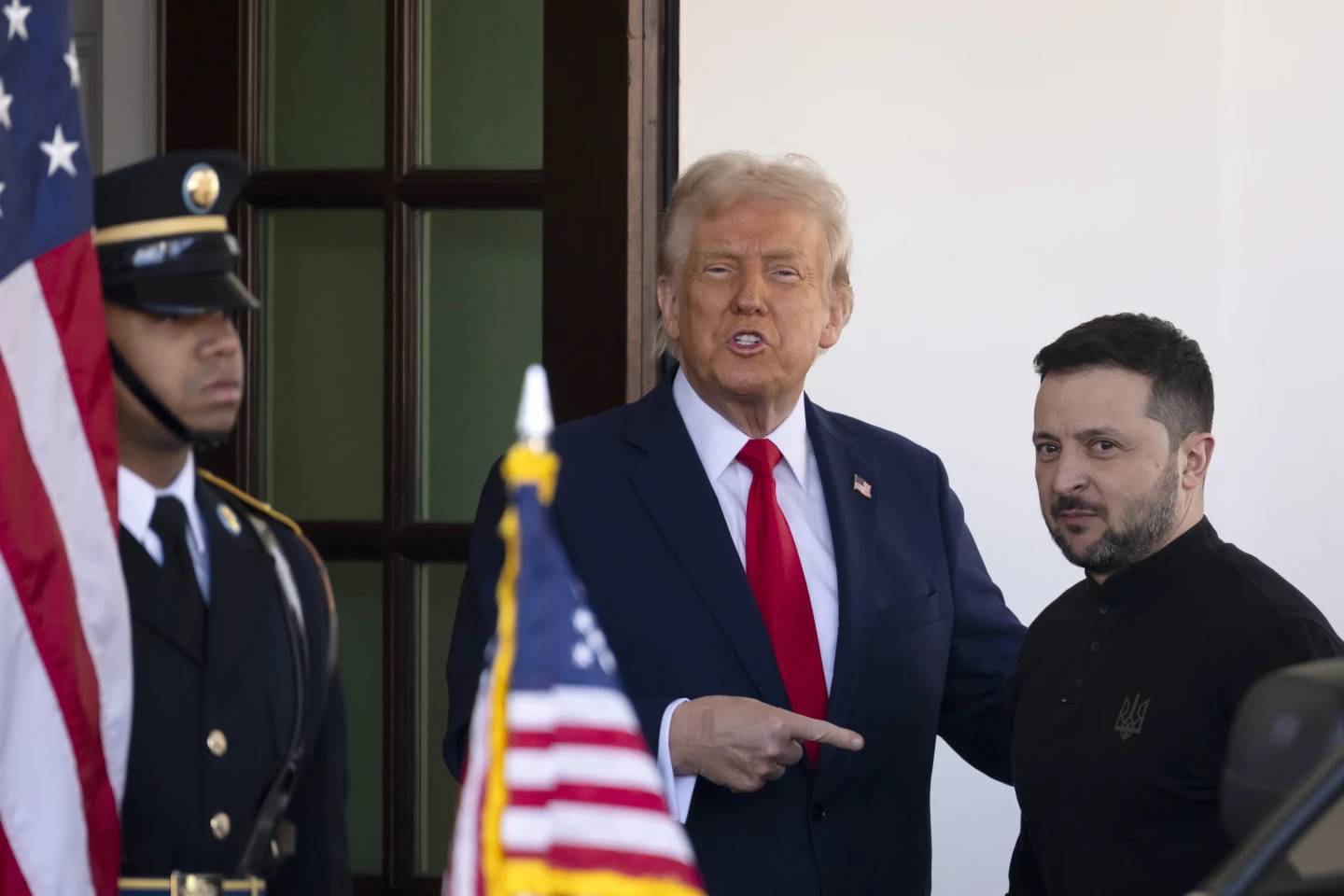 Ukraine President Volodymyr Zelenskyy, right, is greeted by President Donald Trump, center, as he arrives at the White House in Washington on Friday, Feb. 28, 2025. (Credit: Ben Curtis/AP.)