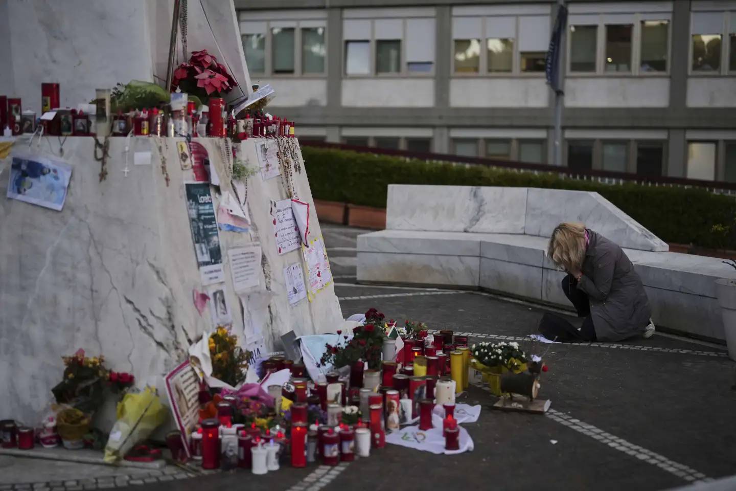 A woman prays next to the statue of Pope John Paul II outside the Gemelli Hospital in Rome, Monday, March 10, 2025. (Credit: Francisco Seco/AP.)