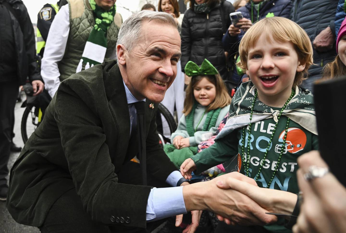 Prime Minister Mark Carney meets young members of the crowd during the annual St. Patrick's Day Parade in Montreal, Sunday March 16, 2025. (Credit: Graham Hughes/The Canadian Press via AP.)