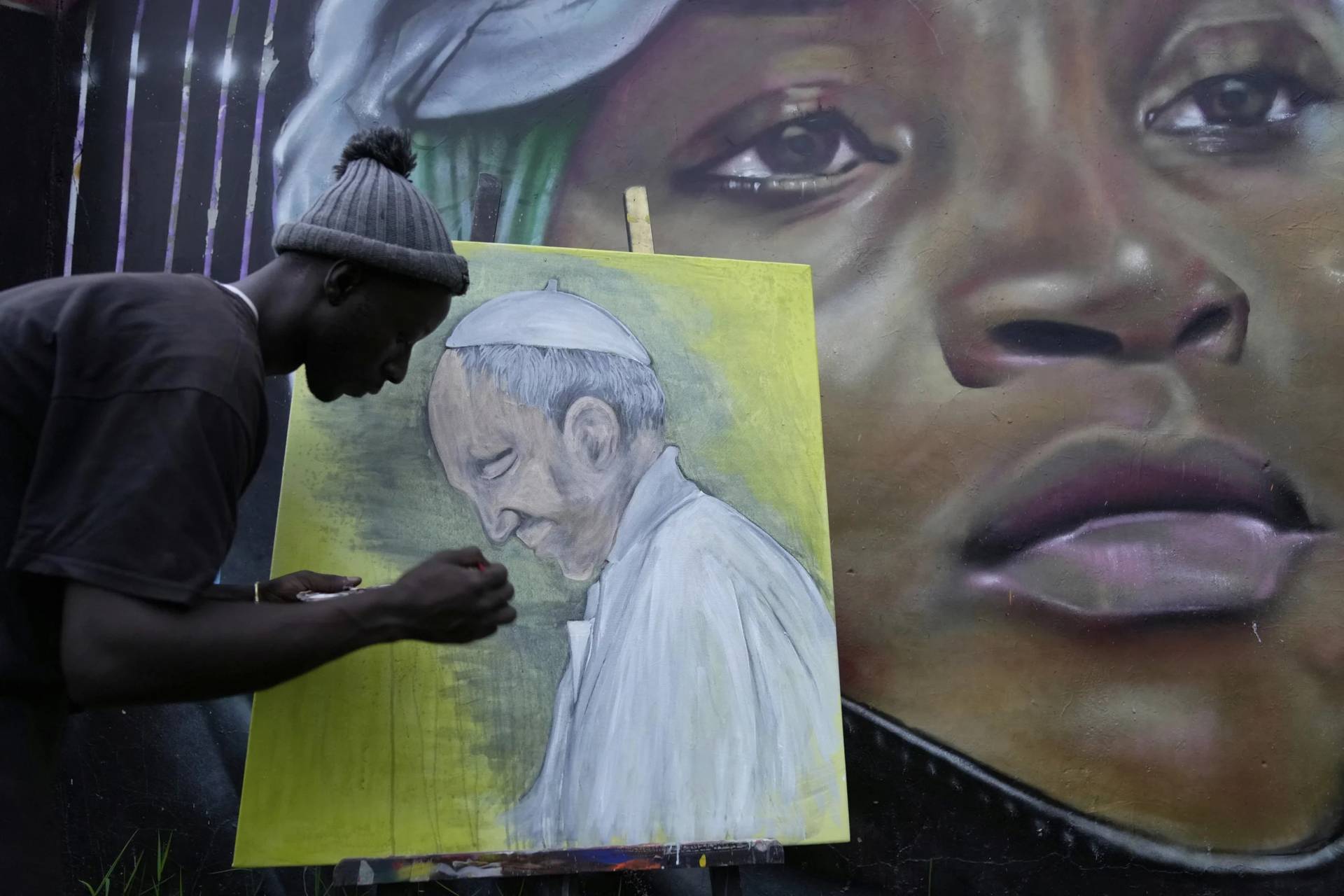Graffiti artist Alexander Ikawah paints Pope Francis on canvas in Nairobi, Kenya, on April 21, 2025. (Credit: Brian Inganga/AP.)